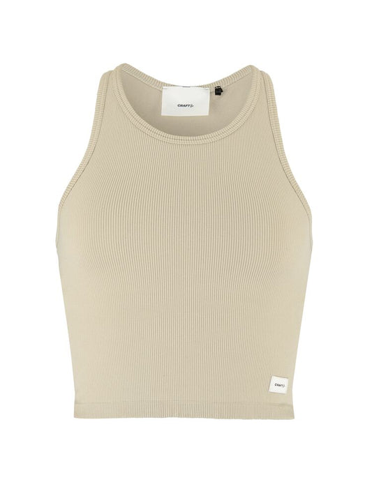 Craft Collective Rib Tank Top W. Sömnlös träningstopp i mjuk och ribbad kvalitet till dam. Kroppsnära passform och ribbad ytstruktur skapar skön och följsam känsla. Beige och med vit Craft etikett nedtill vänster fram. 
